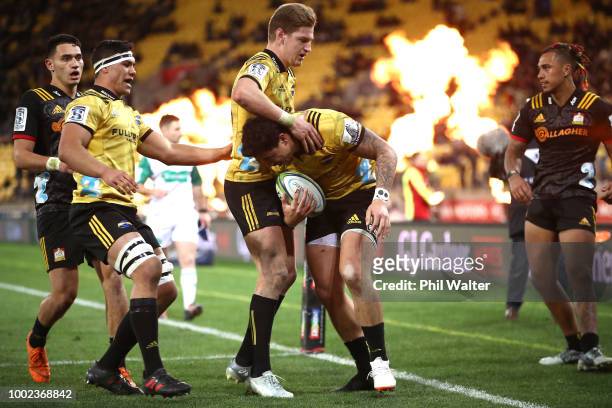 Ben Lam of the Hurricanes scores a try and is congratulated by Jordie Barrett during the Super Rugby Qualifying Final match between the Hurricanes...