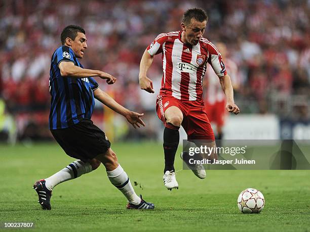 Ivica Olic of Bayern Muenchen is challenged by Lucio of Inter Milan during the UEFA Champions League Final match between FC Bayern Muenchen and Inter...