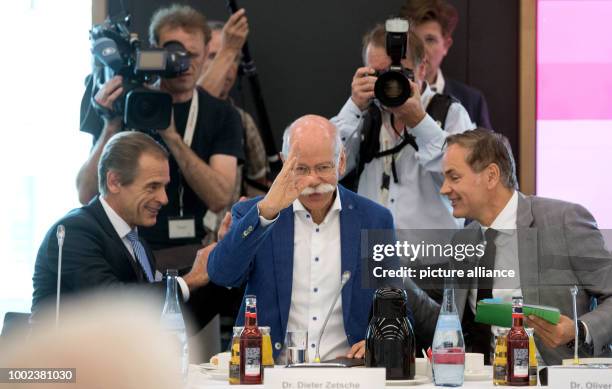 July 2018, Germany, Stuttgart: Dieter Zetsche, CEO of Daimler AG , Oliver BLume , CEO of Porsche AG, and Volkmar Denner , CEO of Robert Bosch GmbH,...