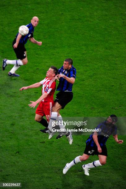 Walter Samuel of Inter Milan jumps for a header with Ivica Olic of Bayern Muenchen during the UEFA Champions League Final match between FC Bayern...