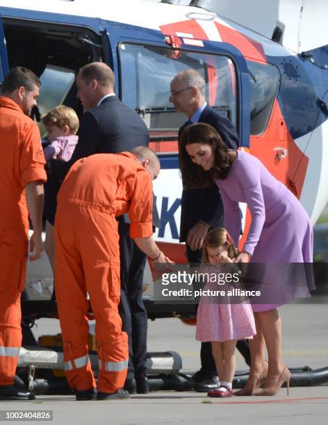 Great Britain's Prince William and Duchess Kate look at an Airbus helicopter with their children George and Charlotte in Hamburg, Germany, 21 July...