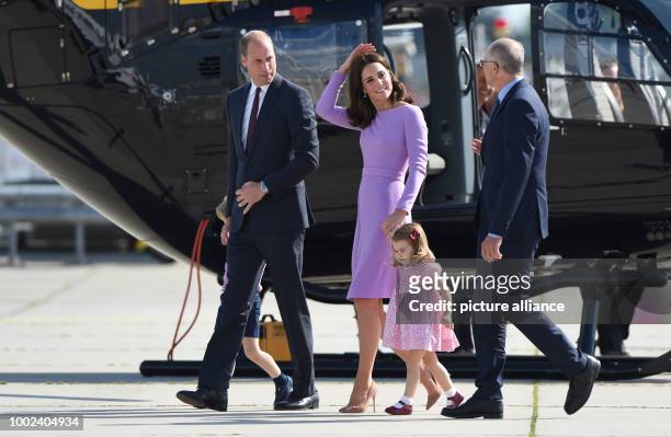 Great Britain's Prince William and Duchess Kate look at an Airbus helicopter with their children George and Charlotte, guided by the CEO of Airbus,...