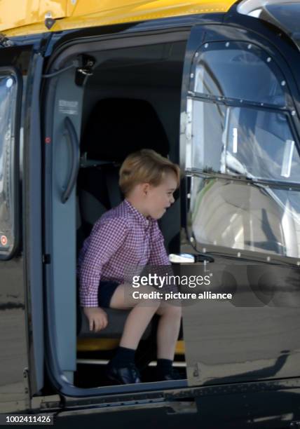 Great Britain's Prince William looks at the interior of a Airbus helicopter with his son George in Hamburg, Germany, 21 July 2017. Hamburg is the...