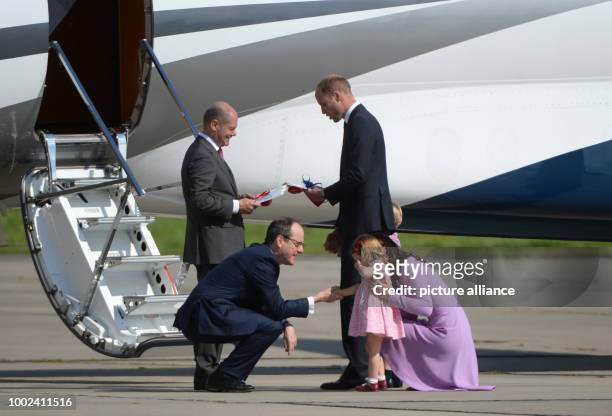 Great Britain's Prince William and Duchess Kate board a plane with their children George and Charlotte in Hamburg, Germany, 21 July 2017. Hamburg is...