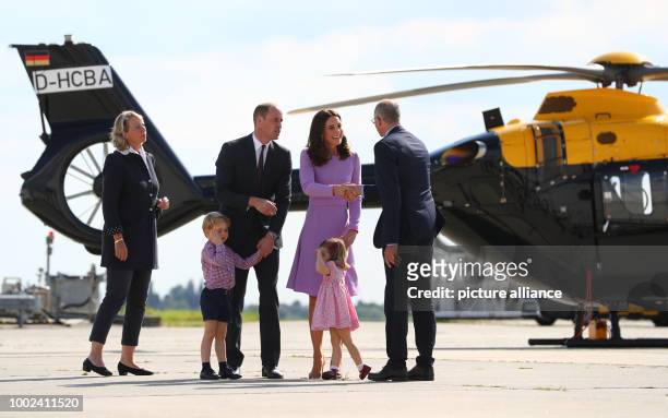 Great Britain's Prince William and Duchess Kate look at an Airbus helicopter with their children George and Charlotte, with the Assembly Line Vice...