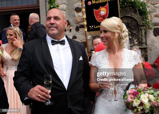 The Hells Angels boss Frank Hanebuth and his wife Sarah exit the St. Michaelis church after their wedding in Bissendorf, Germany, 22 July 2017. The...