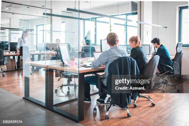 web designers working at desk in creative office - work station stock pictures, royalty-free photos & images