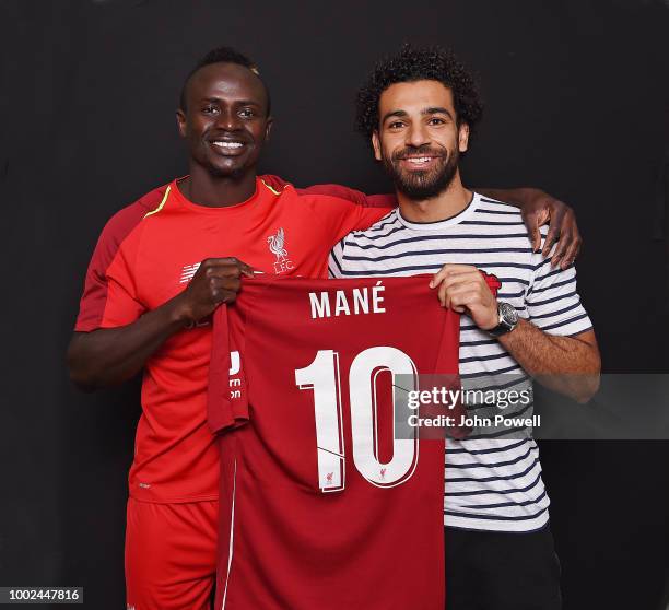 Sadio Mane of Liverpool poses with the new number 10 shirt with Mohamed Salah at Melwood Training Ground on July 20, 2018 in Liverpool, England.