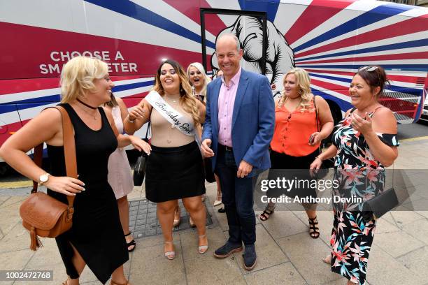 Phil Spencer poses with a hen party beside the Smart Energy bus after Phil Spencer was at Trinity Shopping as part of the Smart Energy GB campaign to...