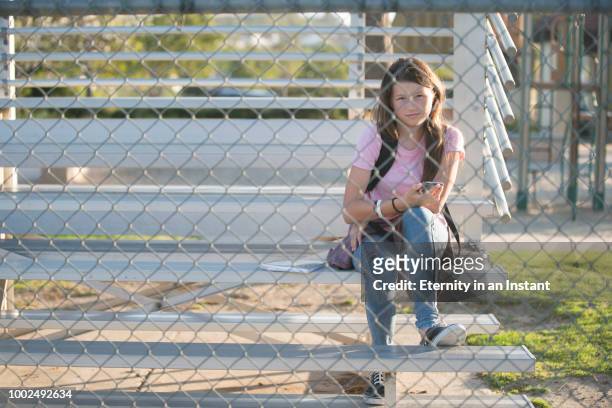 young teenage girl hanging out at school - girl who stands stock pictures, royalty-free photos & images