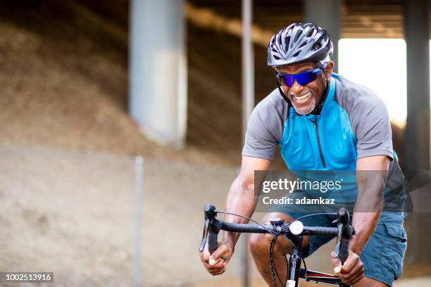 senior black man riding bike on trail - bicycle trail outdoor sports stock pictures, royalty-free photos & images