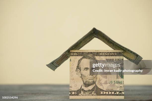 property concept, home investment and real estate concept - house made from money stock pictures, royalty-free photos & images