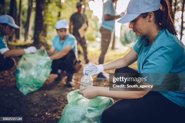 cleaning the environment together - environmentalist stock pictures, royalty-free photos & images