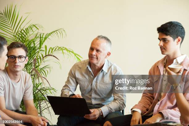 young men attending a group counselling session in queensland - australian training session stock pictures, royalty-free photos & images