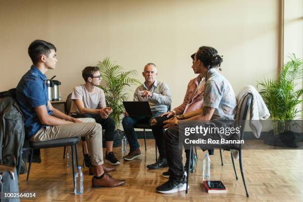 young men attending a group counselling session in queensland - australia training session stock pictures, royalty-free photos & images