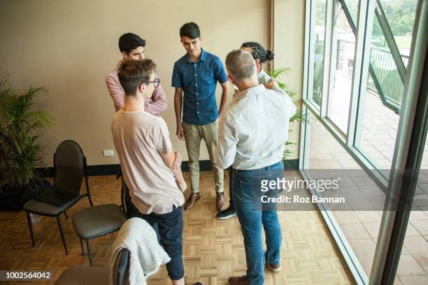 young men attending a group counselling session in queensland - australian training session stock pictures, royalty-free photos & images