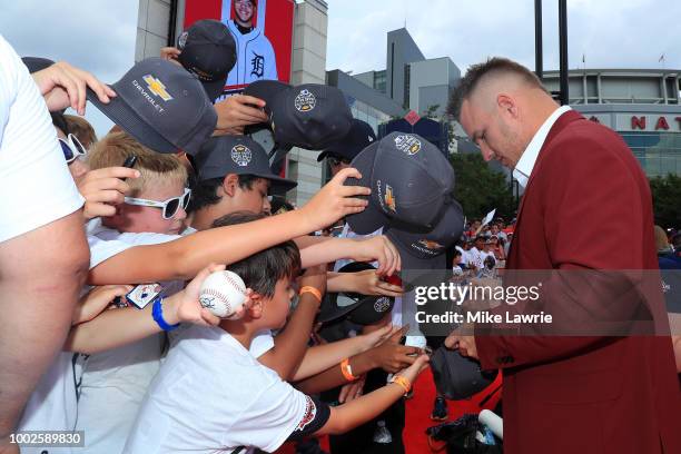 Mike Trout of the Los Angeles Angels of Anaheim and the American League signs autographs for fans at the 89th MLB All-Star Game, presented by...