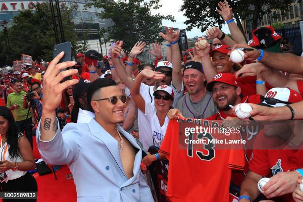 Manny Machado of the Baltimore Orioles and the American interacts with fans at the 89th MLB All-Star Game, presented by MasterCard red carpet at...
