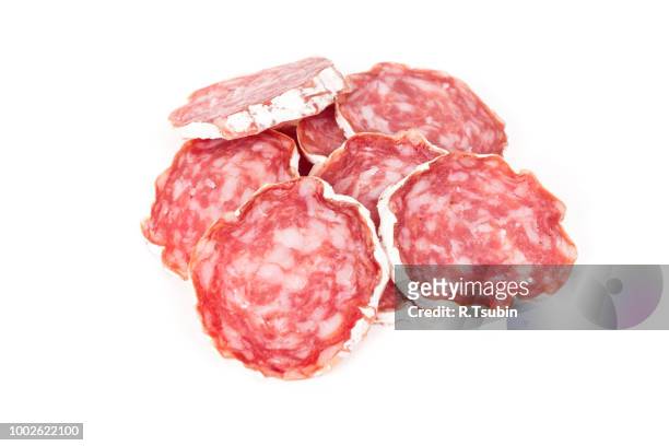 slices of salami isolated on a white background - chorizo stockfoto's en -beelden