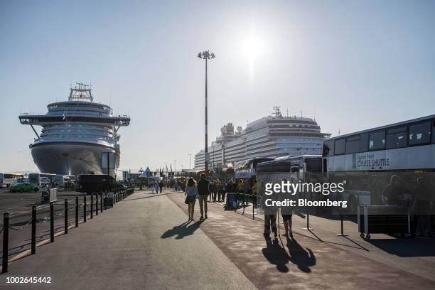 Passengers wait for shuttle buses at the Ogden Point Cruise Terminal in Victoria, British Columbia, Canada, on Friday, July 13, 2018. Canadian...