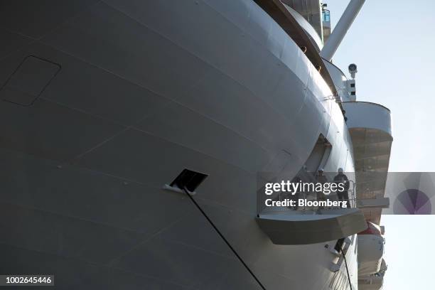Dock hands work to secure a newly arrived cruise ship at the Ogden Point Cruise Terminal in Victoria, British Columbia, Canada, on Friday, July 13,...