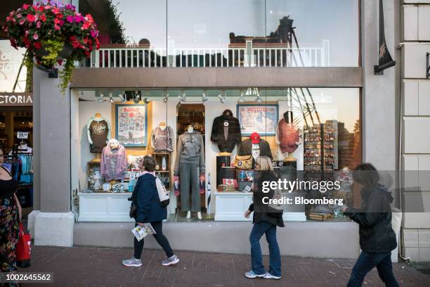 Pedestrians pass in front of souvenir stores in downtown Victoria, British Columbia, Canada, on Friday, July 13, 2018. Canadian tourism spending rose...