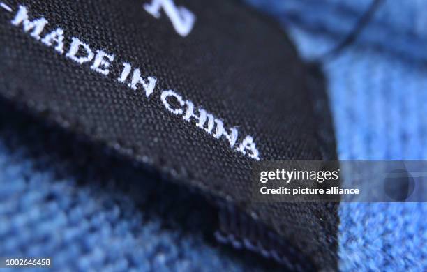 Made in China' label on a jumper in Kempten, Germany, 15 May 2017. Photo: Karl-Josef Hildenbrand/dpa