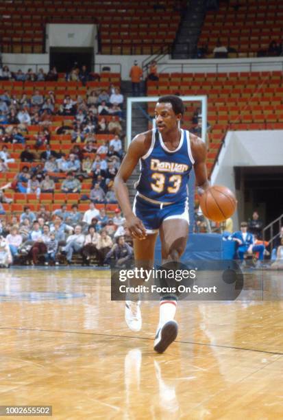 David Thompson of the Denver Nuggets dibbles the ball against the Indiana Pacers during an NBA basketball game circa 1981 at Market Square Arena in...