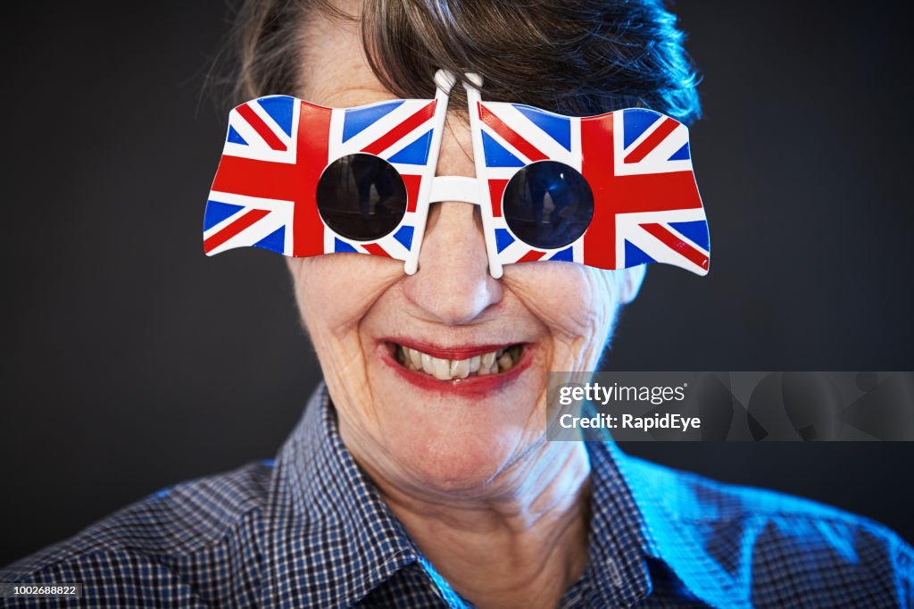 Smiling old woman in patriotic Union Jack sunglasses