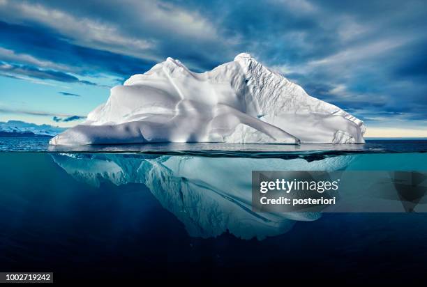 iceberg with above and underwater view taken in greenland. - antarctica iceberg stock pictures, royalty-free photos & images