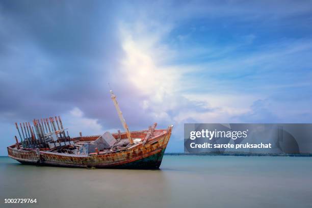 old shipwreck boat abandoned stand on beach with blue sky . - brisbane beach stock pictures, royalty-free photos & images