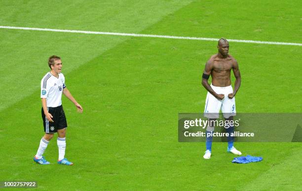 File picture dated 28 June 2012 shows Germany's Philipp Lahm and Italy's Mario Balotelli reacting during the UEFA EURO 2012 semi-final between...