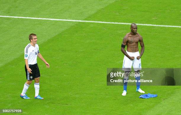 File picture dated 28 June 2012 shows Germany's Philipp Lahm and Italy's Mario Balotelli reacting during the UEFA EURO 2012 semi-final between...