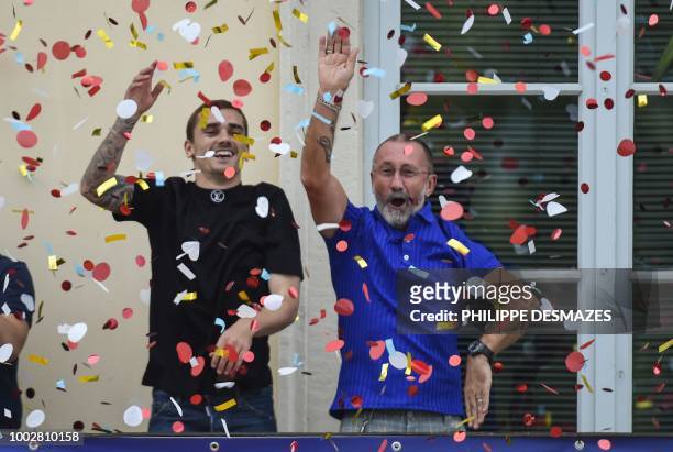 French football player Antoine Griezmann and his father Alain greet fans in his hometown of Macon, eastern France on July 20 after French players won...