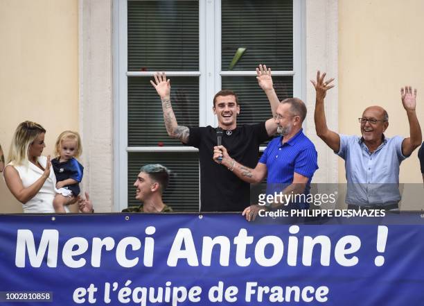 French football player Antoine Griezmann greets fans in his hometown of Macon, eastern France, on July 20 flanked by his father Alain , his wife...