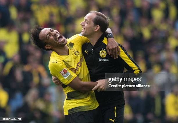 Dortmund's Pierre-Emerick Aubameyang and manager Thomas Tuchel celebrate at the end of the German Bundesliga soccer match between Bayern Munich and...