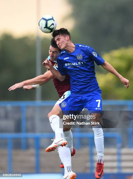 Oliver Crankshaw of Curzon Ashton and Stephen Ward of Burnley compete for the ball during a pre-season friendly match between Curzon Ashton and...