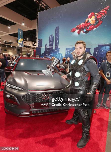 Fans in cosplay pose with the Hyundai Kona Iron Man Edition at the Marvel booth at San Diego Comic-Con at the San Diego Convention Center on July 19,...