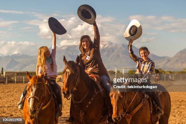 cowboy family mother and children salute on horse at santaquin salt lake city slc utah usa - child saluting stock pictures, royalty-free photos & images