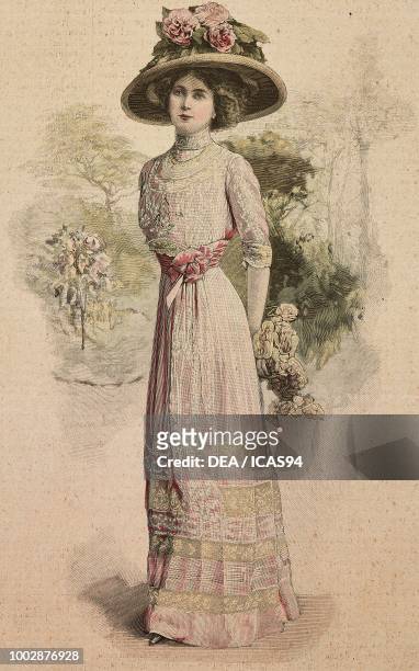 Woman wearing a summer dress in white fine linen on see-through pink satin, embroidered Valenciennes lace inserts and a hat with flowers, creation by...