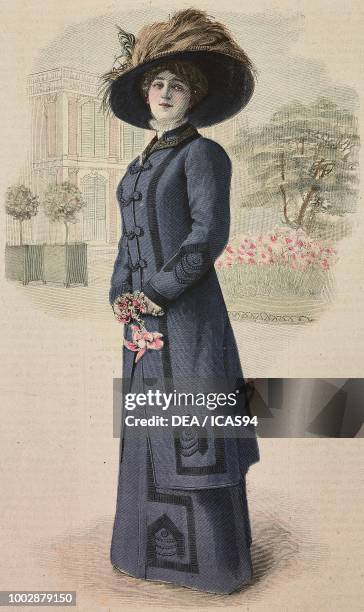 Woman wearing a blue Serge suit, round skirt with plaited patterns, coat with plaited motifs hat with feathers, creation by Green, colored engraving...