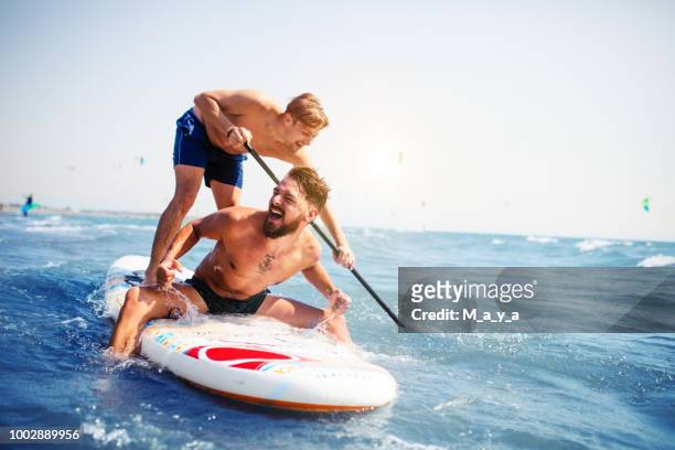 summer fun - paddle surf stock pictures, royalty-free photos & images