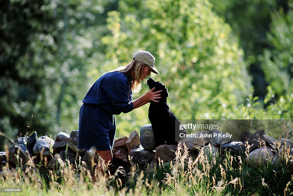YOUNG WOMAN WITH PUPPY DOG IN WESTERN COLORADO