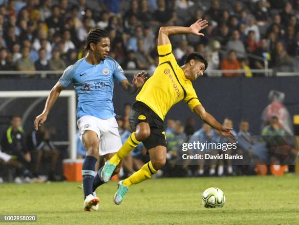 Jack Harrison of Manchester City and Mahmoud Dahoud of Borussia Dortmund go for the ball on July 20, 2018 at Soldier Field in Chicago, Illinois....