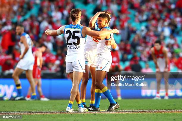 Jarryd Lyons and Touk Miller of the Suns celebrate victory during the round 18 AFL match between the Sydney Swans and the Gold Coast Suns at Sydney...