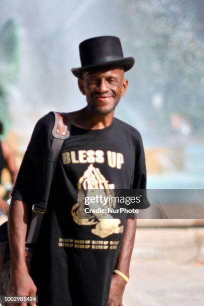 Man wearing a hat poses in front of the fountain at Logan Square a nice summer day, in Philadelphia, PA on July 20, 2018.