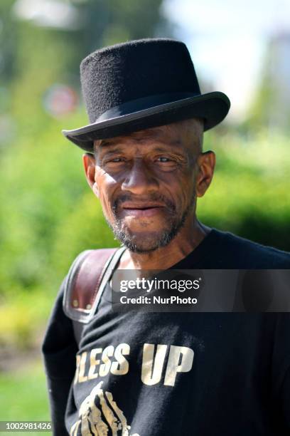 Man wearing a hat poses at Logan Square a nice summer day, in Philadelphia, PA on July 20, 2018.