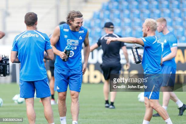 Micheal Hefele shares a joke with Alex Pritchard of Huddersfield Town during the Huddersfield Town pre-season training session at the PSD Bank Arena...