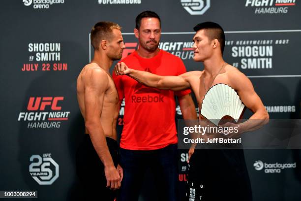 Opponents Damian Stasiak of Poland and Pingyuan Liu of China face off during the UFC Fight Night Weigh-in event at the Radisson Blu Hotel on July 21,...