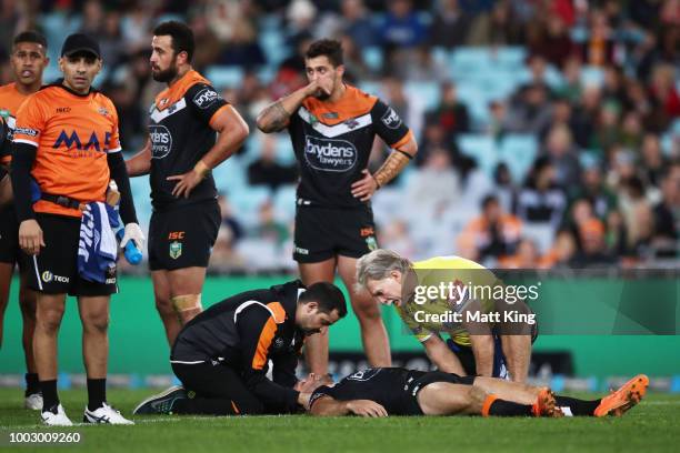 Robbie Farah of the Tigers lies down after sustaining an injury during the round 19 NRL match between the Wests Tigers and the South Sydney Rabbitohs...